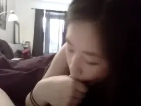 Asian babe gives blowjob