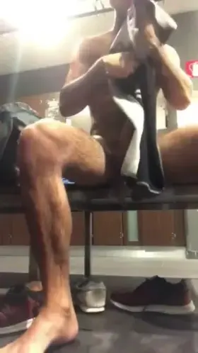 Playing with his hard cock in the locker room