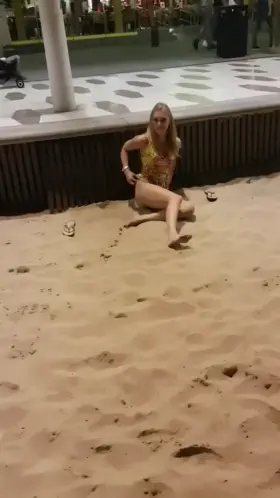 There is a naughty girl in the sand